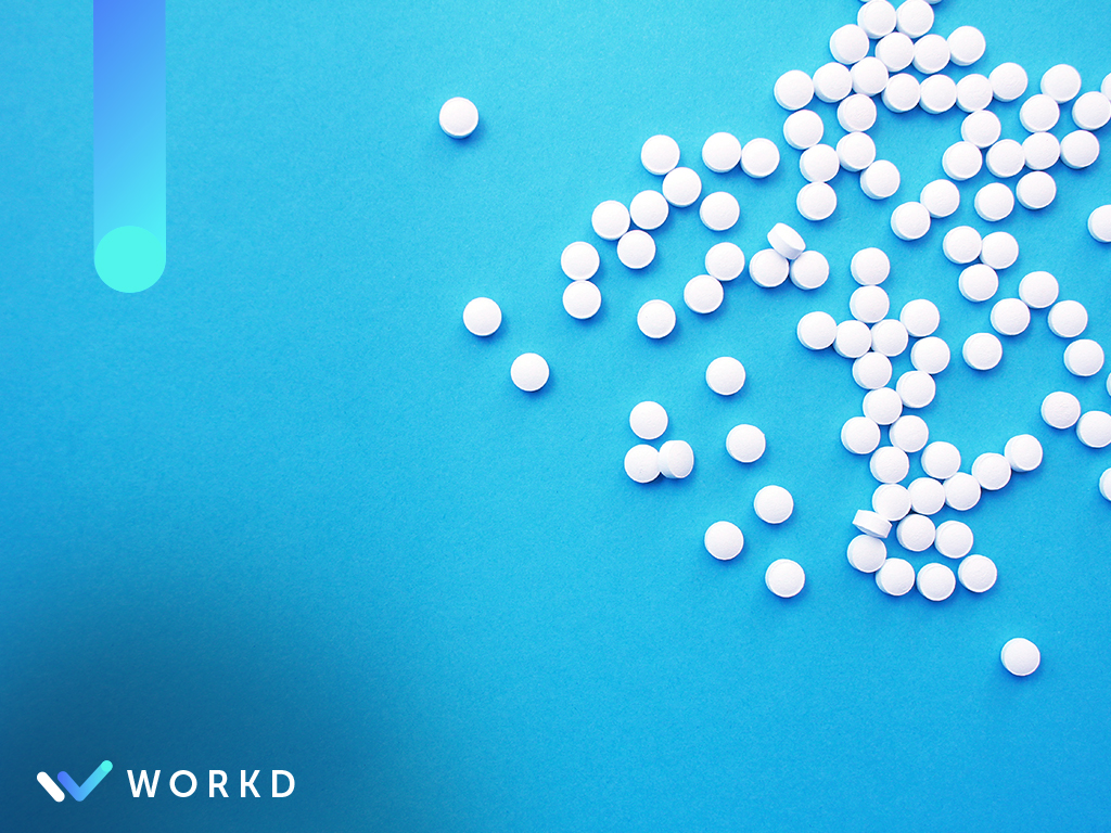 Photo of scattered pills to represent DSCSA. The Workd logo in the lower left corner