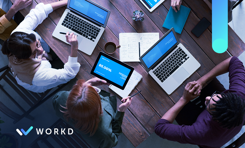 Using Your CRM For Lead Conversion. A team sitting at a table.